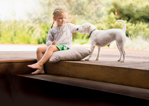 colorcote little girl and dog on deck